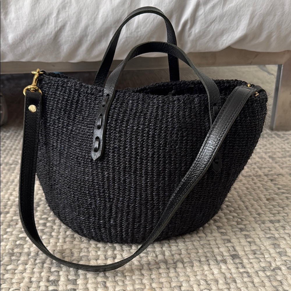 Clare V Pot de Miel 
Black woven rattan w/ leather handles & shoulder strap.